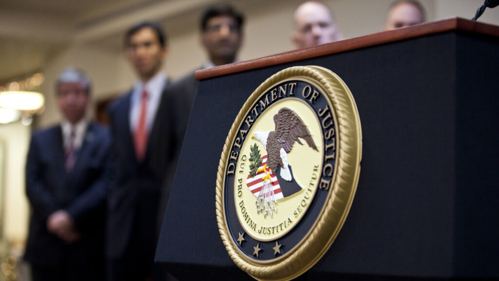The Justice Department previously declined to comment on how it is implementing President Trump’s executive order, but most diversity programs there appear to have been put on hold since autumn. A U.S. Department of Justice seal is displayed on a podium during a news conference in 2012. (Ramin Talaie/Getty Images)