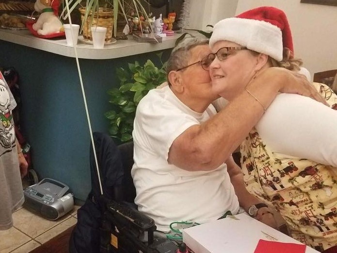 A resident of the Cordell Christian Home in Cordell, Okla., kisses Mrs. Claus at the annual holiday party in 2017