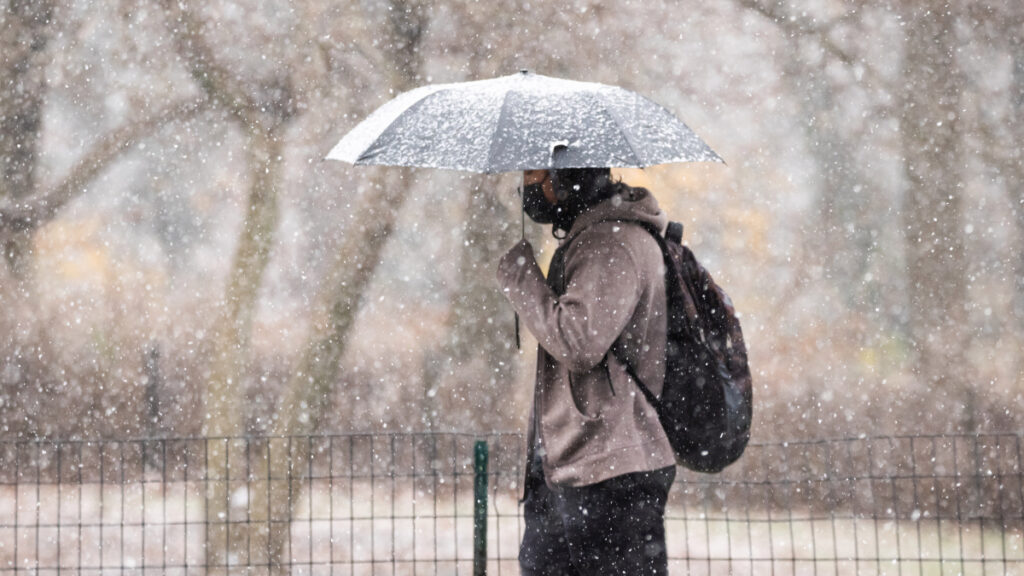 winter_weather_NBC10_121520 A person holds up an umbrella during wintry weather