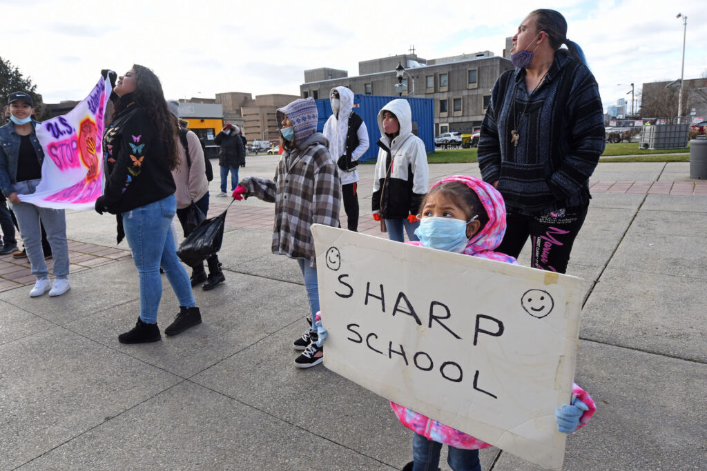 01 (2) At a Jan. 6 protest at Camden's City Hall, Ivonne Escobedo Rojas, 5, holds up a sign with the name of Sharp School. Sharp is among several public schools in the city that may be closed by the end of this month. (April Saul for WHYY)