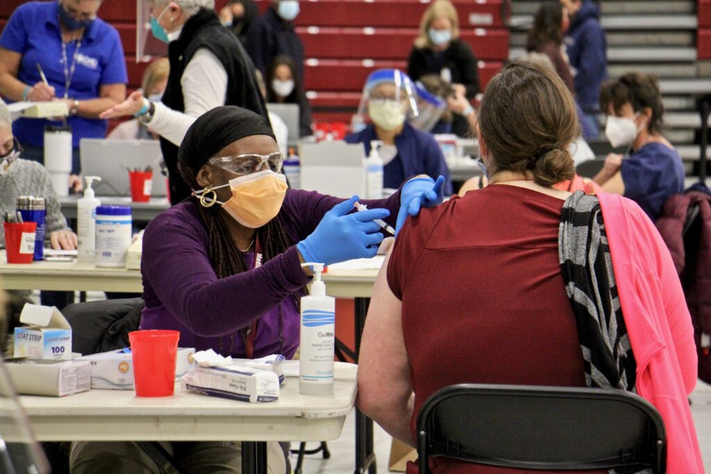 2021 01 06-e lee-starlette sumpter-blue bell pa montgomery county community college-covid vaccination clinic Licensed practical nurse Starlette Sumpter administers COVID-19 vaccinations at a clinic