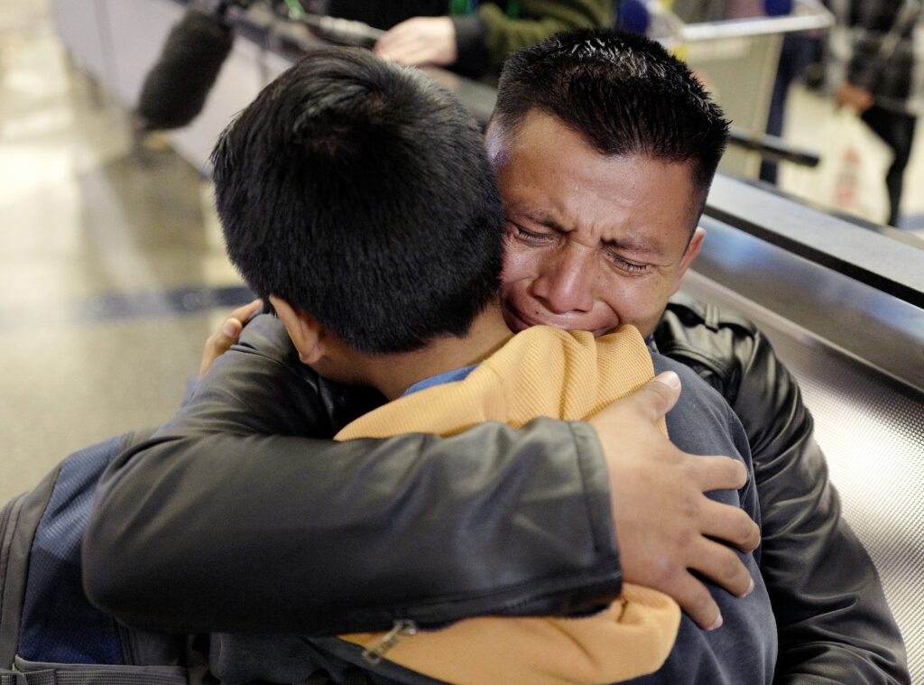 Immigration Separated Families FILE - In this Wednesday, Jan. 22, 2020, file photo, David Xol-Cholom, of Guatemala, hugs his son Byron at Los Angeles International Airport as they reunite after being separated during the Trump administration's wide-scale separation of immigrant families, in Los Angeles. A court-appointed committee has yet to find the parents of 628 children separated at the border early in the Trump administration. (AP Photo/Ringo H.W. Chiu, File)