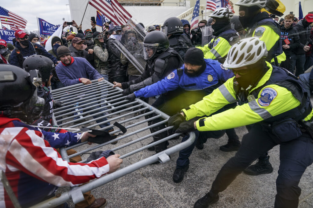 Electoral College Protests Pro-Trump insurrectionists try to break through a police barrier, Wednesday, Jan. 6, 2021, at the Capitol in Washington.