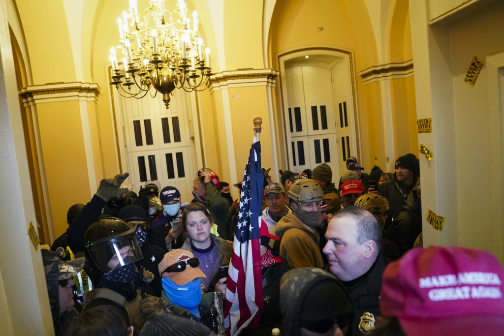 Electoral College Protests Supporters of President Donald Trump stand inside the U.S. Capitol on Wednesday, Jan. 6, 2021, in Washington. (AP Photo/John Minchillo)