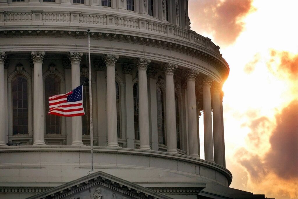 Capitol Under Siege In this July 24, 1998, file photo, a flag flies at half-staff on Capitol Hill in honor of two Capitol police officers who were killed after a gunman burst through security barriers. (AP Photo/Doug Mills)
