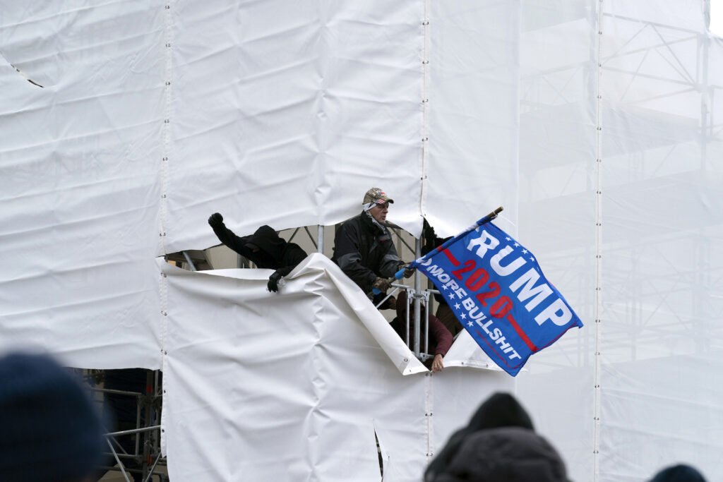 Electoral College Photo Gallery Pro-Trump insurrectionists gather outside the Capitol, Wednesday, Jan. 6, 2021, in Washington. (AP Photo/Jose Luis Magana)