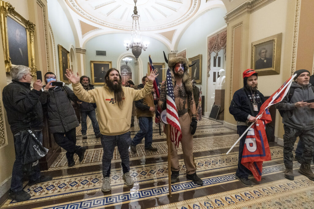 Pro-Trump insurrectionists are confronted by Capitol Police officers outside the Senate Chamber