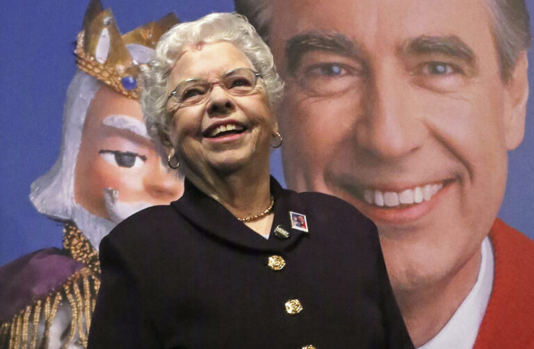 Fred Rogers wife, Mrs. Joanne Rogers, stands in front of a giant Mister Rogers Forever Stamp following the first-day-of-issue dedication in WQED's Fred Rogers Studio in Pittsburgh, Friday, March 23, 2018. (AP Photo/Gene J. Puskar)