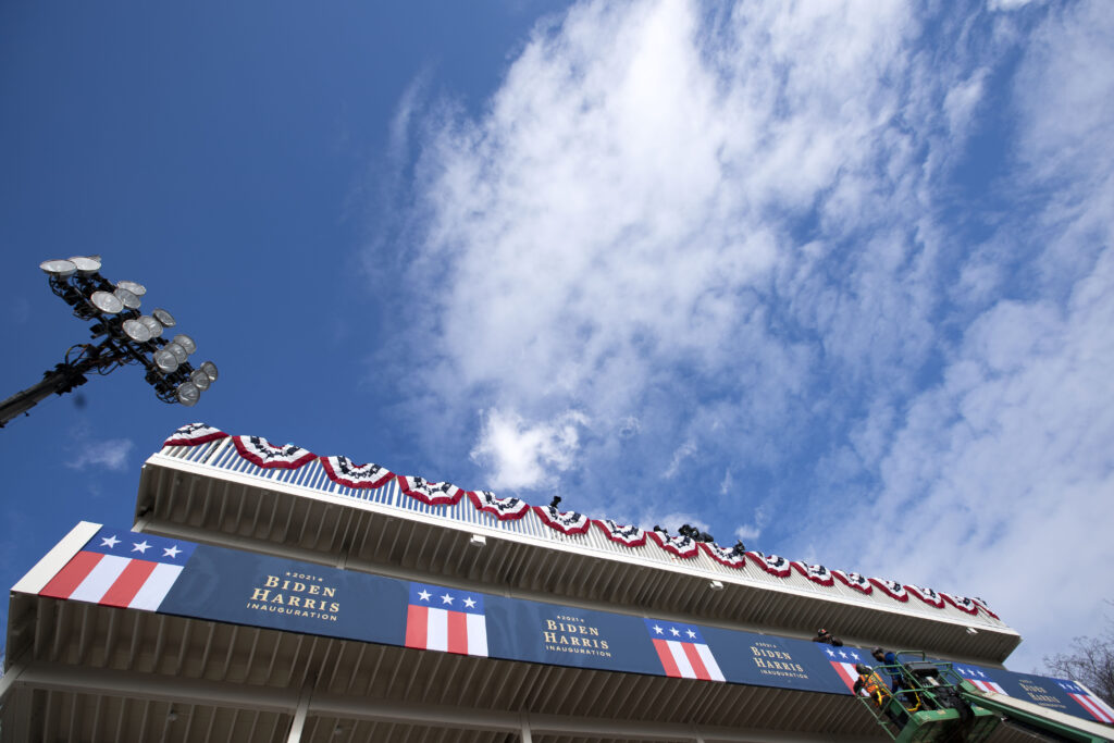 Biden Inauguration Security Workers install a banner on a platform near the White House as preparations are made for President-elect Joe Biden's inauguration ceremony, Monday, Jan. 18, 2021, in Washington. (AP Photo/Jose Luis Magana)