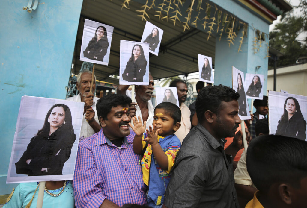 APTOPIX India Kamala Harris A child reacts as villagers hold placards featuring U.S. Vice President-elect Kamala Harris after participating in special prayers ahead of her inauguration, outside a Hindu temple in Thulasendrapuram, the hometown of Harris' maternal grandfather, south of Chennai, Tamil Nadu state, India, Wednesday, Jan. 20, 2021. A tiny, lush-green Indian village surrounded by rice paddy fields was beaming with joy Wednesday hours before its descendant, Kamala Harris, takes her oath of office and becomes the U.S. vice president. (AP Photo/Aijaz Rahi)
