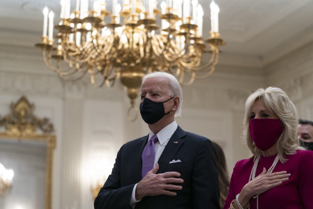 Joe Biden, Jill Biden President Joe Biden, accompanied by first lady Jill Biden, places his hand over his heart during a performance of the national anthem, during a virtual Presidential Inaugural Prayer Service in the State Dinning Room of the White House, Thursday, Jan. 21, 2021, in Washington. (AP Photo/Alex Brandon)