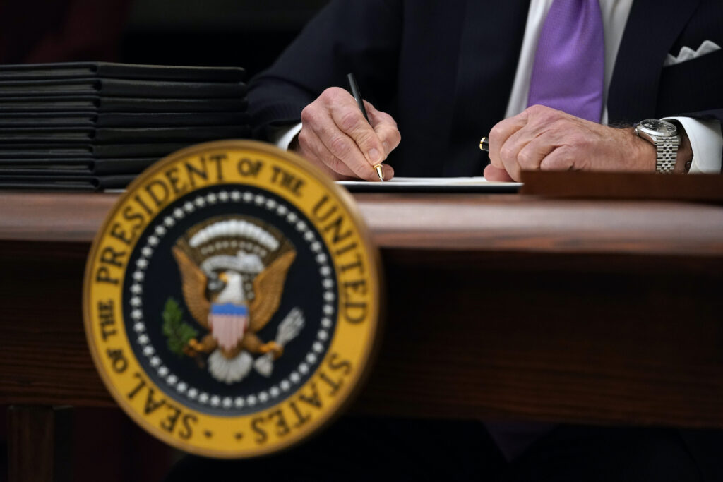 Joe Biden President Joe Biden signs executive orders after speaking about the coronavirus in the State Dinning Room of the White House, Thursday, Jan. 21, 2021, in Washington. (AP Photo/Alex Brandon)