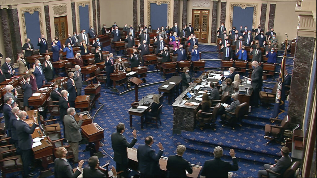 Trump Impeachment In this image from video, Sen. Patrick Leahy, D-Vt., the president pro tempore of the Senate, who is presiding over the impeachment trial of former President Donald Trump, swears in members of the Senate for the impeachment trial at the U.S. Capitol in Washington, Tuesday, Jan. 26, 2021. (Senate Television via AP)