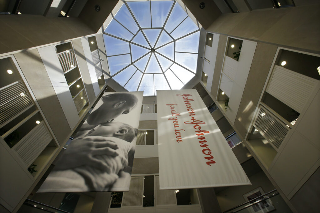 Johnson & Johnson In this July 30, 2013, file photo, large banners hang in an atrium at the headquarters of Johnson & Johnson in New Brunswick, N.J. (AP Photo/Mel Evans)