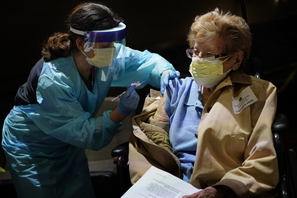 Virus Outbreak New Jersey Helen Fitzpatrick, 97, right, receives a COVID-19 vaccine administered by Dr. Hillary Cohen at Englewood Health