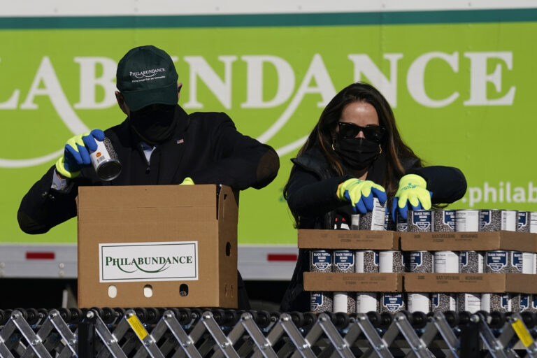 President-elect Joe Biden, left, participates in a National Day of Service event at Philabundance