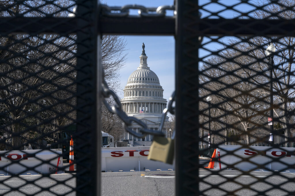 With the U.S. Capitol in the background, a lock on anti-scaling security fencing is seen