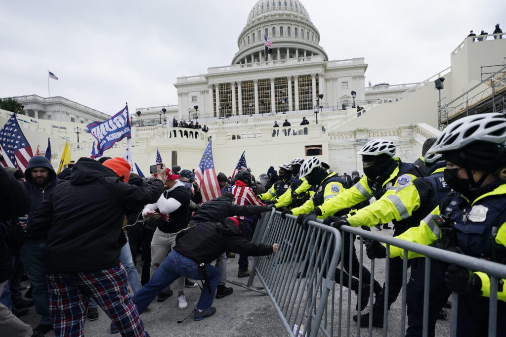 APTOPIX Electoral College Protests Pro-Trump insurrectionists try to break through a police barrier, Wednesday, Jan. 6, 2021, at the Capitol in Washington.