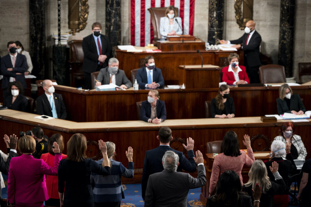 House Speaker Nancy Pelosi administers the oath of office to members of the 117th Congress