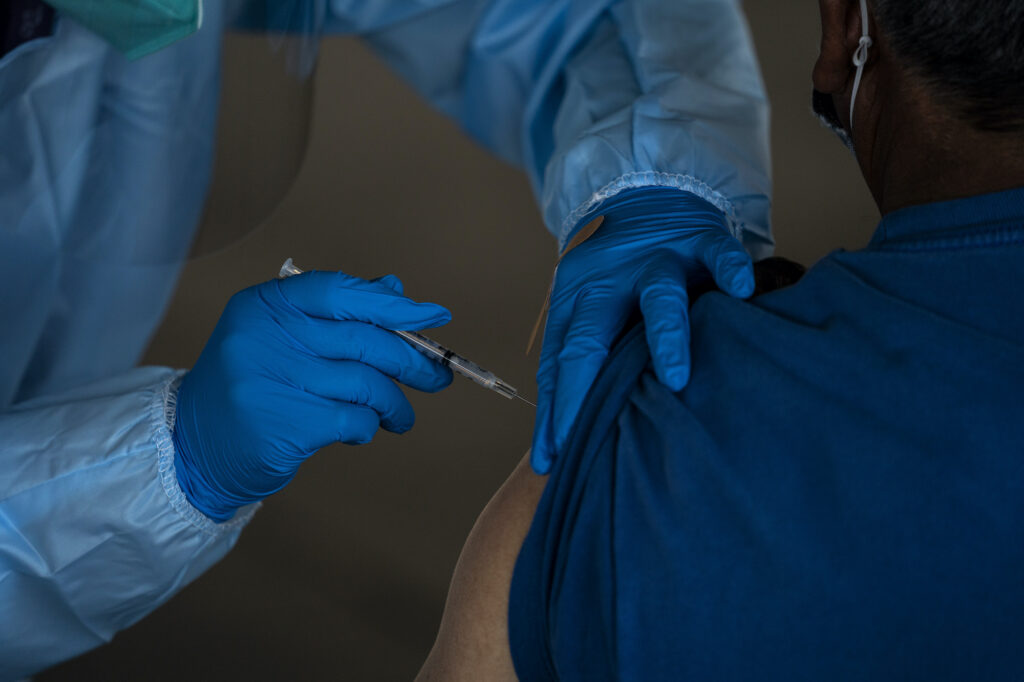 A person receives the Pfizer-BioNTech COVID-19 vaccine