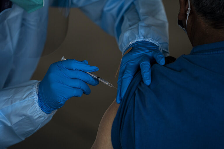 A person receives the Pfizer-BioNTech COVID-19 vaccine