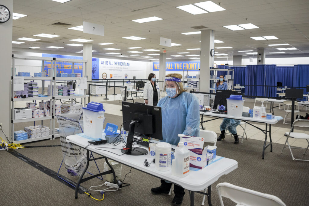 Virus Outbreak Health care workers prepare to give COVID-19 vaccinations at a former Sears store turned in to a vaccination site, in Rockaway, N.J.