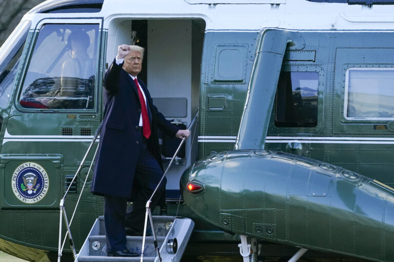 President Donald Trump gestures as he boards Marine One on the South Lawn of the White House