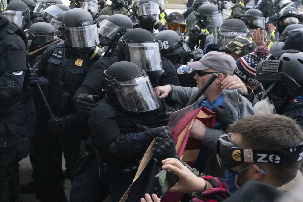 Electoral College Protests Capitol police officers in riot gear push back pro-Trump insurrectionists who try to break a door of the U.S. Capitol