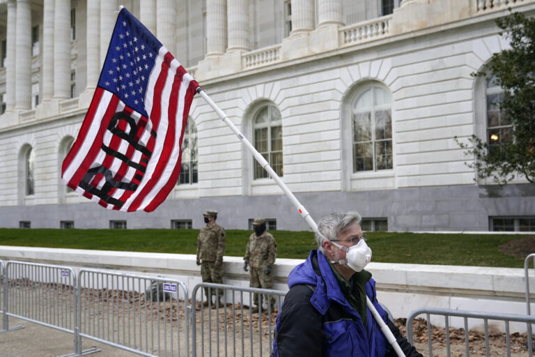 A protester walks past the Russell Senate Office Building on Capitol Hill