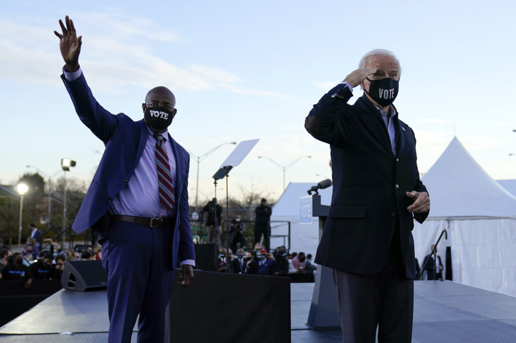 President-elect Joe Biden campaigns in Atlanta, Monday, Jan. 4, 2021, for Senate candidates Raphael Warnock, left, and Jon Ossoff