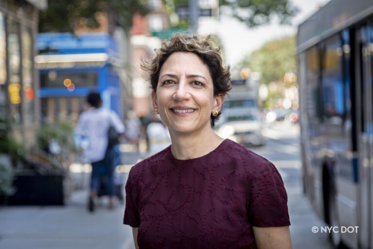 Polly Trottenberg stands outside on the street.