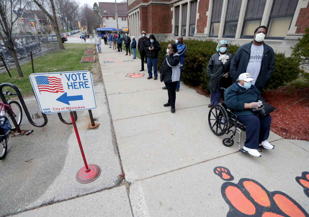 Rosie Redmon waits with her son to vote in the presidential primary election in Milwaukee FRONTLINE: Whose Vote Counts