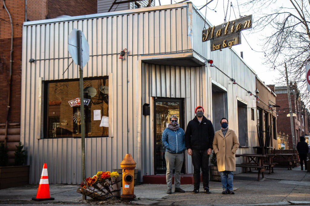 IMG_2600 Neighbors Allison Sacks (left), Brayden Varr (center) and Christie Vazquez (right) outside the Station Bar at 16th and McKean streets in South Philadelphia. (Kimberly Paynter/WHYY)