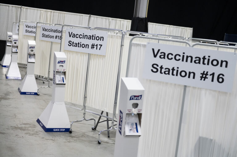 Vaccination stations at the New Jersey Convention and Exposition Center Covid-19 vaccination site in Edison, New Jersey, U.S., on Friday, Jan. 15, 2021. New Jersey will expand Covid-19 vaccinations to people 65 years old and over and those ages 16 to 64 who have 