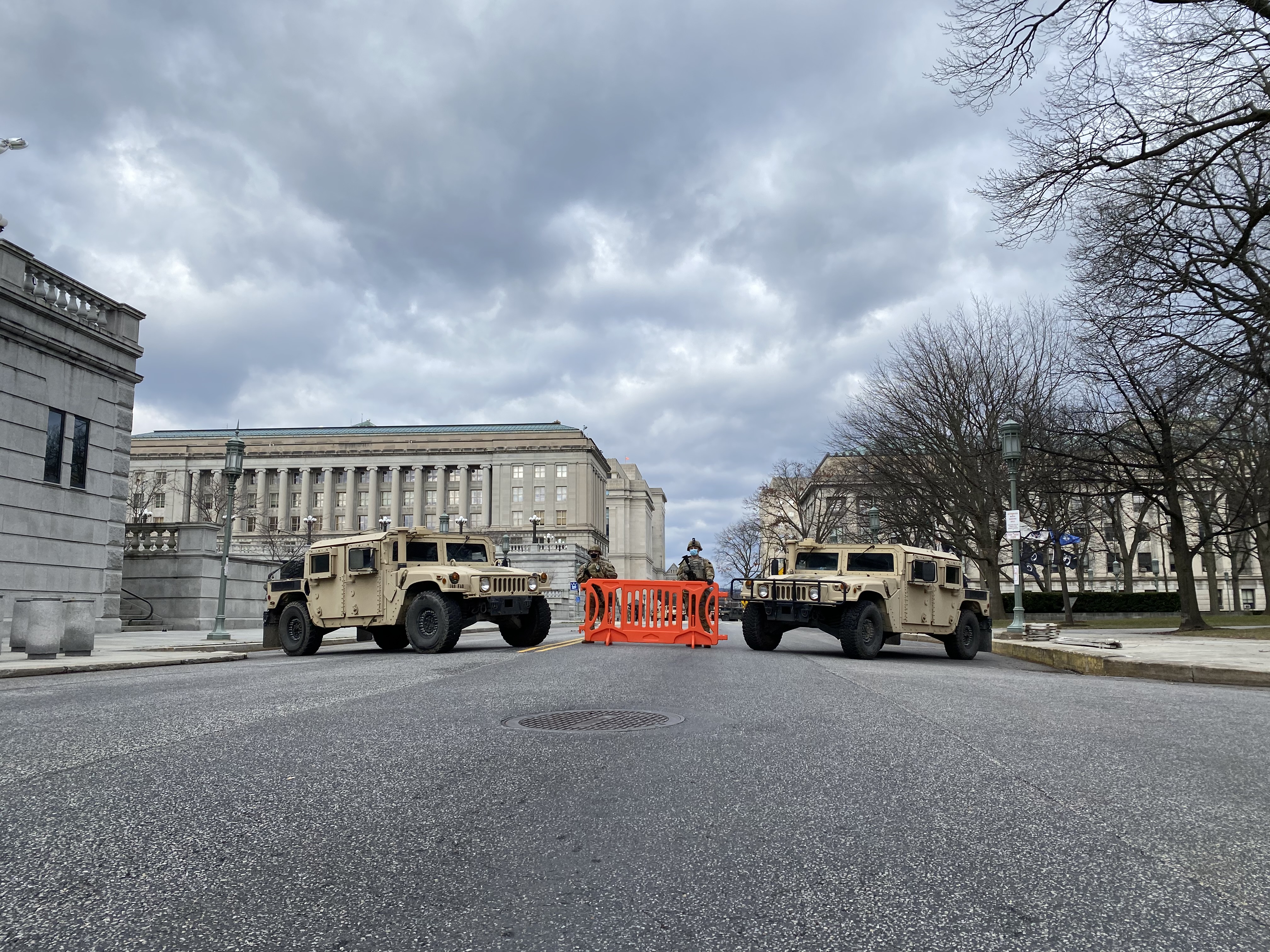Two armored humvees are parked on a street near the Pa. state Capitol