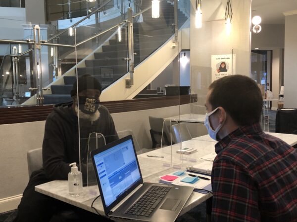 David Hicks (left) meets with case manager Tim Keeler. (Cris Barrish/WHYY)
