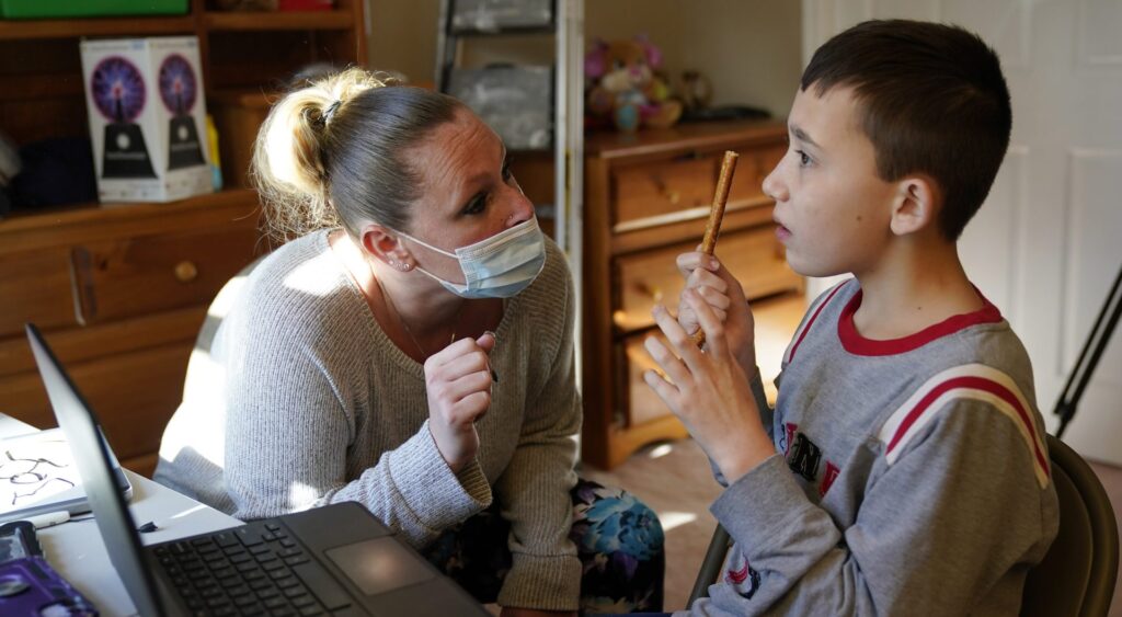 Wein Josh Nazzaro Paraprofessional Jessica Wein helps Josh Nazzaro, who lives with autism, with his classwork while attending class virtually from his home