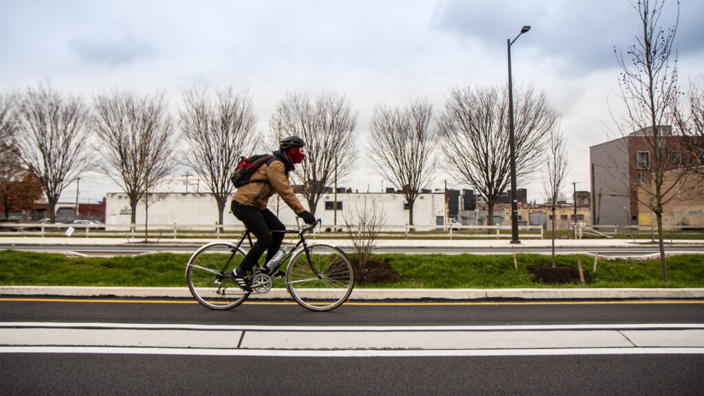 A biker uses the raised bike lanes on American Street. (Kimberly Paynter/WHYY) A biker uses the raised bike lanes on American Street.