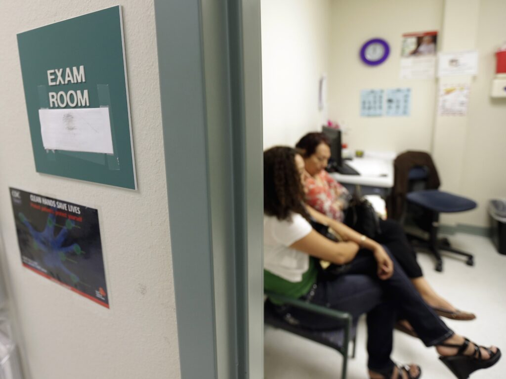 President Biden will sign executive orders Thursday that would revoke a Trump-era policy cutting funds to global organizations that offer abortion and to expand access to health insurance. Two women wait in an exam room at Nuestra Clinica Del Valle