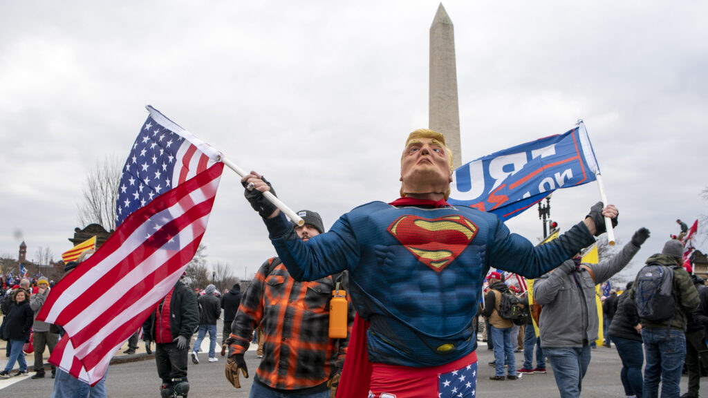 With the Washington Monument in the background, people attend a rally in support of President Donald Trump