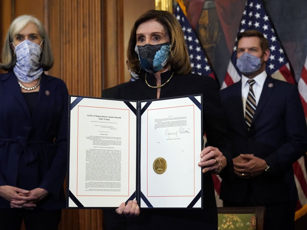 Nancy Pelosi House Speaker Nancy Pelosi of Calif., displays the signed article of impeachment against President Donald Trump
