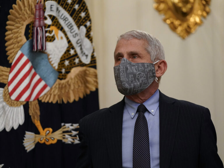 Dr. Anthony Fauci wears a face mask inside the State Dining Room of the White House