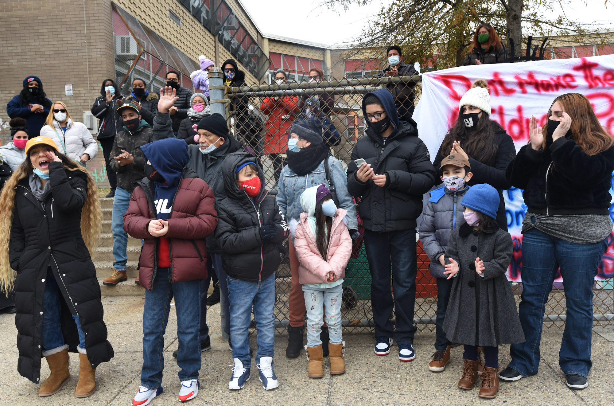 Maria Montero, left, leads a protest against school closures at Wiggins School