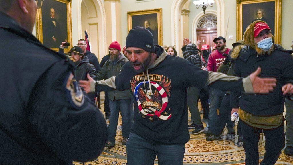 Pictures of the Week Photo Gallery-North America A pro-Trump insurrectionist gestures to U.S. Capitol Police in the hallway outside of the Senate chamber