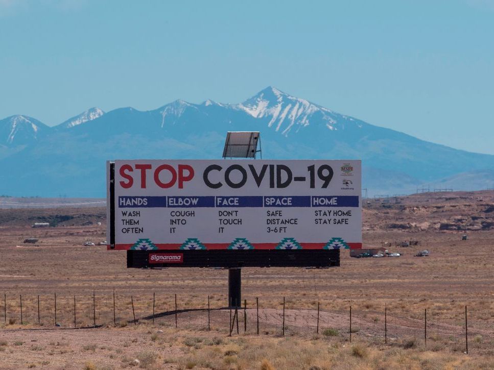 A sign warns against COVID-19 near the Navajo town of Tuba City, Ariz. As the pandemic rages across the U.S., mitigation measures continue to be critical to save lives. A sign warns against COVID-19 near the Navajo town of Tuba City, Ariz. As the pandemic rages across the U.S., mitigation measures continue to be critical to save lives. (Mark Ralston/AFP via Getty Images)