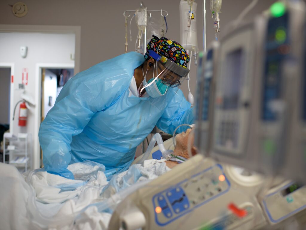Healthcare worker Demetra Ransom comforts a patient in the Covid-19 ward at United Memorial Medical Center in Houston, Texas on December 4, 2020. The U.S. has surpassed 20 million confirmed coronavirus cases. Health care worker Demetra Ransom comforts a patient in the Covid-19 ward at United Memorial Medical Center in Houston,