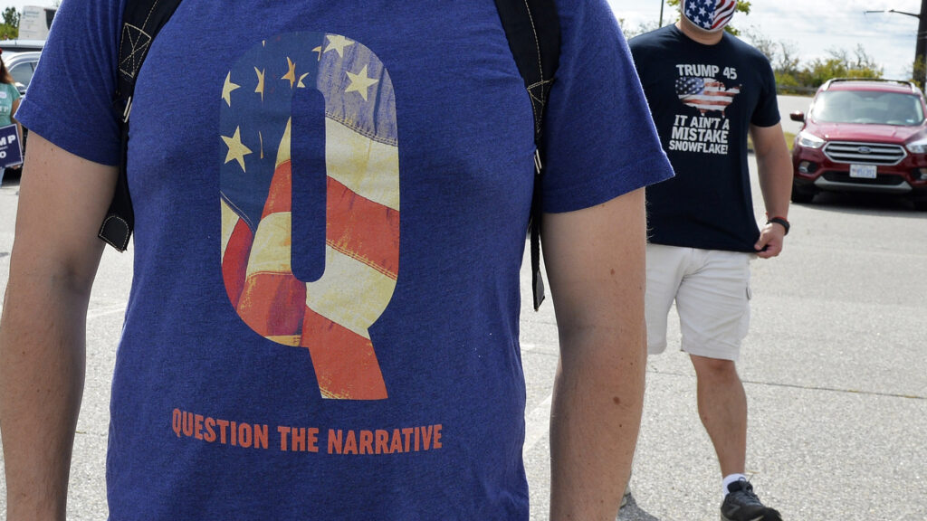 A man wears a QAnon shirt while boarding a shuttle bus in Londonderry, N.H., on Aug. 28, 2020. A man wears a QAnon shirt while boarding a shuttle bus in Londonderry, N.H., on Aug. 28, 2020. (Joseph Prezioso/AFP via Getty Images)