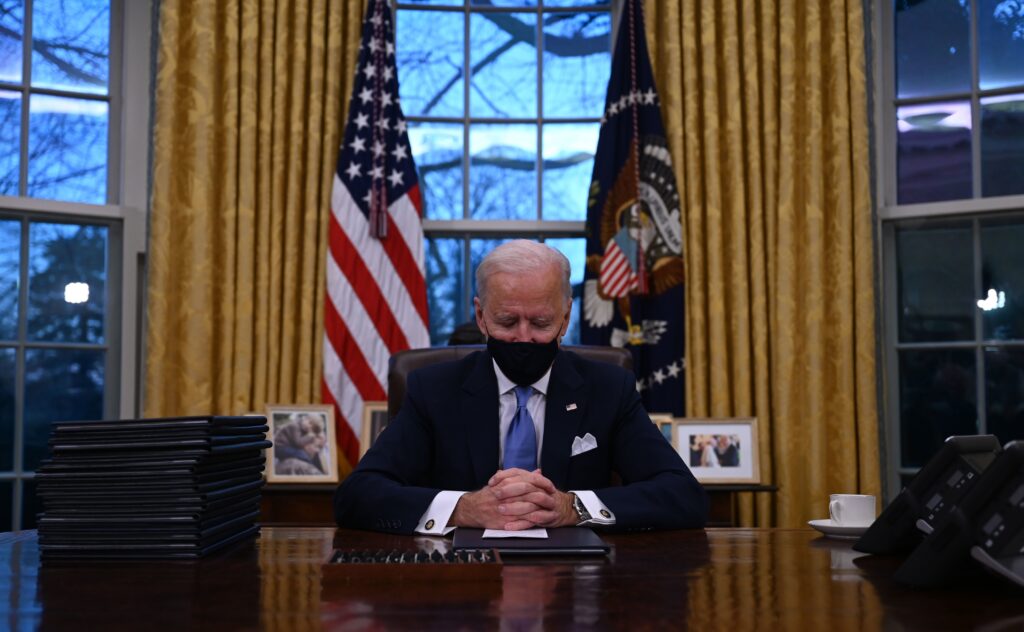 President Biden sits in the Oval Office at the White House after being sworn in as the 46th president of the United States on Wednesday. President Biden sits in the Oval Office at the White House