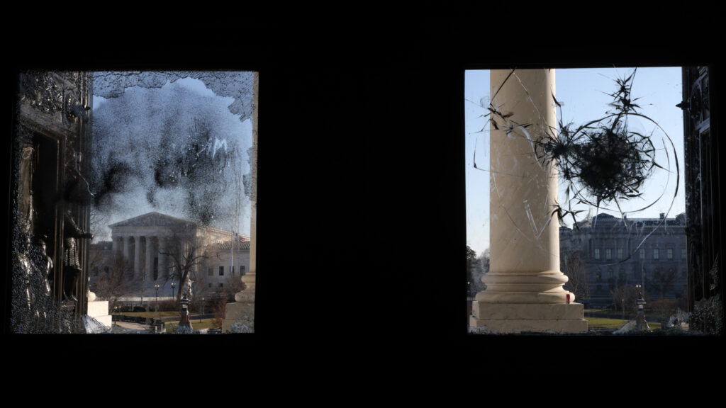 The U.S. Supreme Court is seen through a broken window at an entrance of the U.S. Capitol Wednesday. The U.S. Supreme Court is seen through a broken window at an entrance of the U.S. Capitol