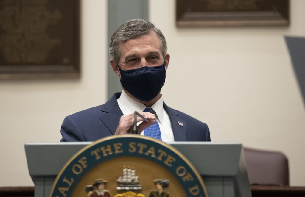 gov_john_carney_generic_04_012821 Delaware Gov. John Carney, wearing a face mask, speaks at a podium